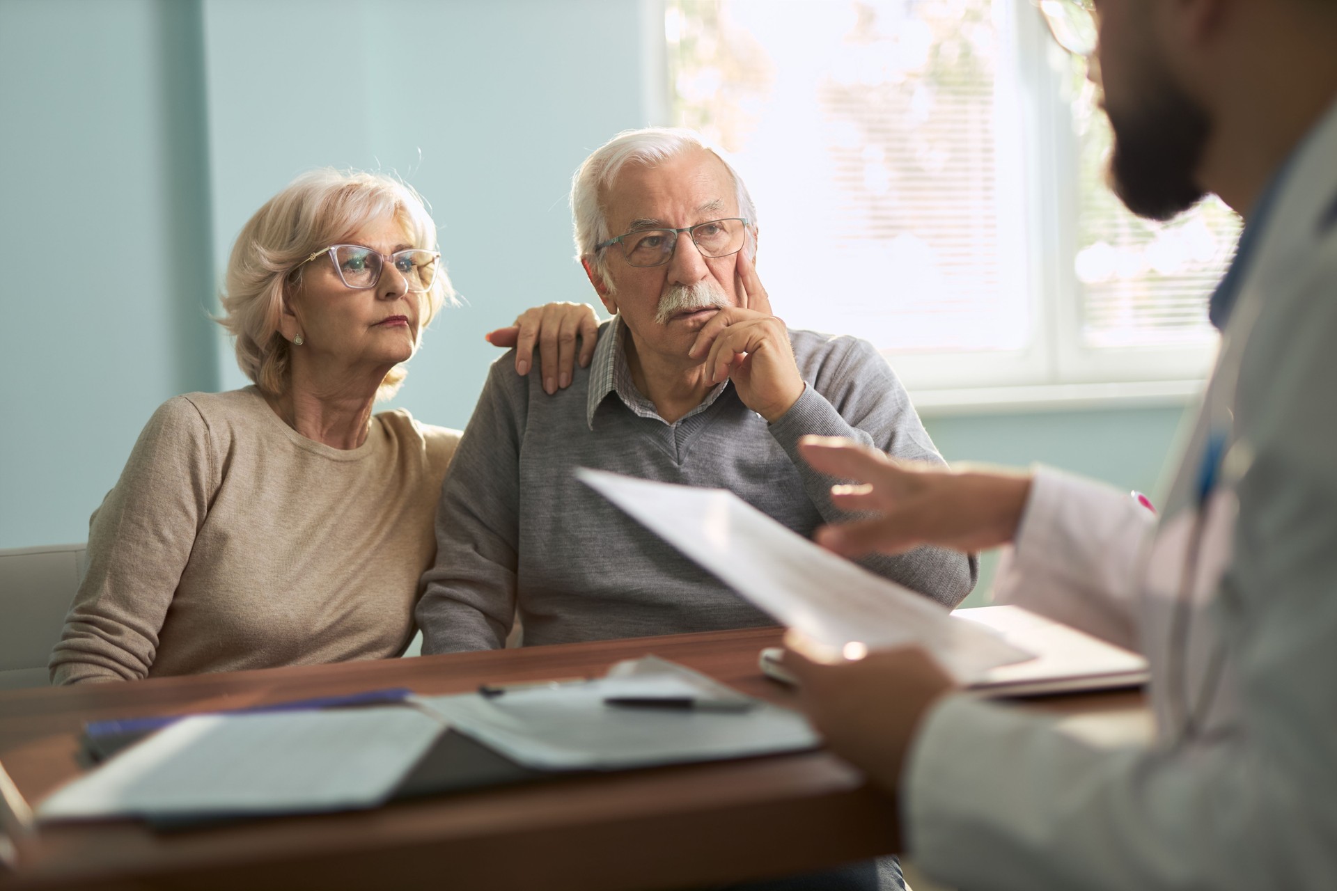 Senior couple  having a consultation with a doctor in the office